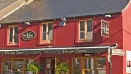 The Vee Café exterior with signage above the entrance and windows on an upper floor.